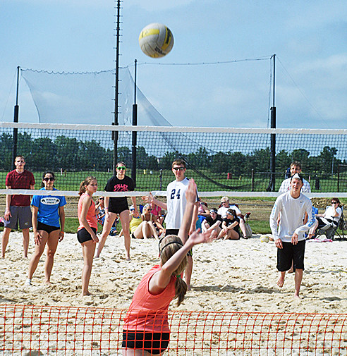 Teens and adults playing sand volleyball on hot, summer day at Field Sports at SportsOhio